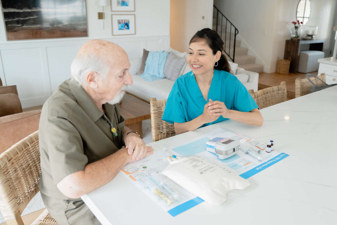 Nurse discussing TPN with patient at his home